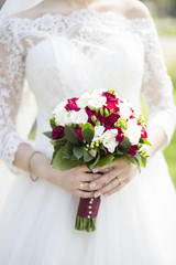 the bride in a white dress is dancing with two hands a wedding bouquet