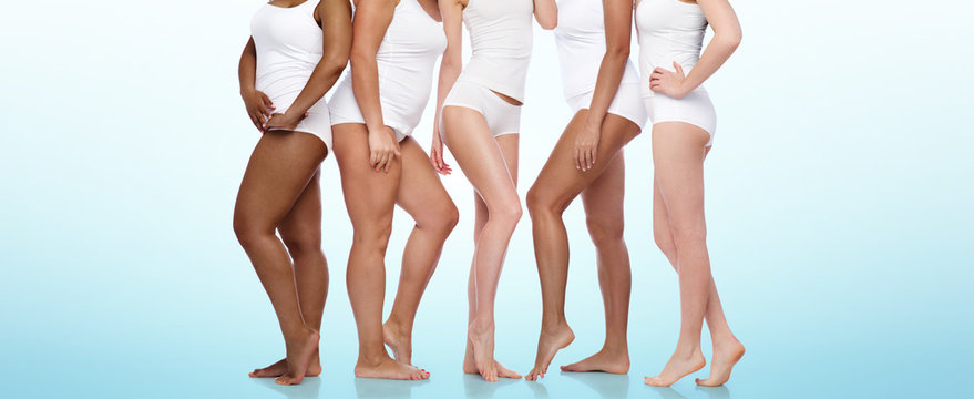 beauty, body positive and people concept - group of diverse women in white underwear over blue background