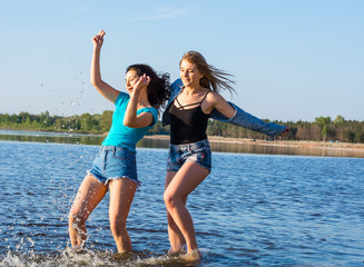 Young people, two women, students are happy on the beach