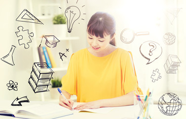 people, education, high school and learning concept - happy asian young woman student with book and notepad writing at home over doodles