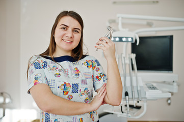 Portrait of baby dentist female at her dental office.