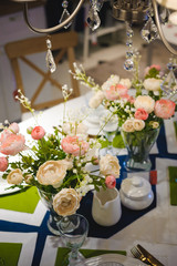 decoration of the kitchen interior, serving a dining table, fresh flowers in a vase