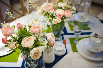 decoration of the kitchen interior, serving a dining table, fresh flowers in a vase