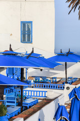 Fototapeta na wymiar Terrace of arabian style restaurant with blue wooden tables and benches