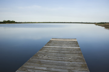 Fototapeta na wymiar Wooden plank deck and lake