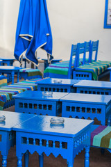 Arabian style restaurant with blue wooden tables and benches 