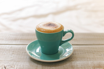 Hot coffee cappuccino isolated on wooden table
