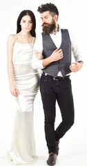 Bearded hipster with bride dressed up for wedding ceremony. Couple in love, bride and groom in elegant wedding clothes, white background. Woman in wedding dress and man in vest. Wedding concept.