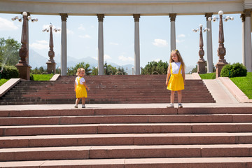 Portrait of happy adorable two sisters children girls outdoor. Cute little kid in summer day