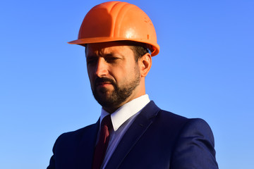Architect controls work. Man with beard and serious face