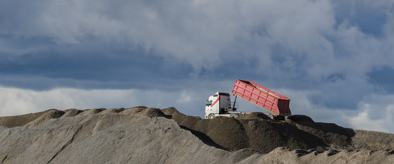 TRUCK - A construction machine on a heap of aggregates