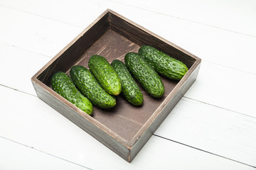Fresh cucumber in brown box, agriculture background.