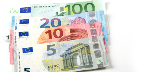 Euro currency on a white background. The denominations are five, ten, twenty and one hundred euros.