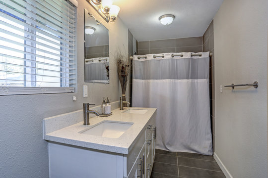 Interior of neutral bathroom with double vanity cabinet