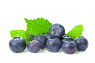 Fresh ripe blueberries with leaves close up isolated on white background. Healthy food.