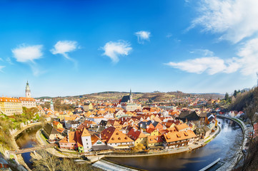 Obraz premium Aerial view panorama of the old Town of Cesky Krumlov in South Bohemia, Czech Republic with blue sky. UNESCO World heritage Site and famous place for tourism