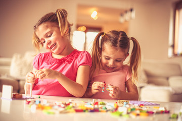 Fototapeta premium You build for self. Little girls playing.