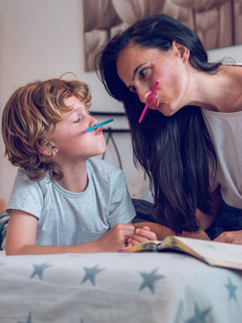 Mother and son having fun with pencils