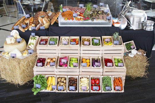 Display of different food at the farmers market or buffet, variety of fruit, vegetables, chees, bread, meat and seafood