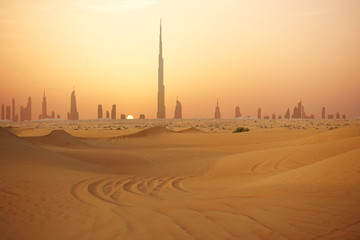 Dubai city skyline at sunset seen from the desert
