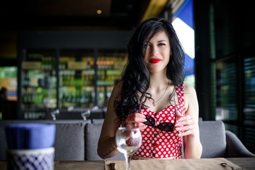 50s vintage style woman at restaurant. Pretty pin-up woman with make-up, vintage style in modern life 