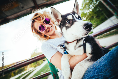 Blonde With Curly Hair In Pink Glasses Sits On The Bench With