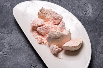 Pink bath salt on black stone background