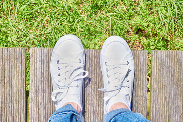 Foot and legs, from above. Selfie of legs on wooden path