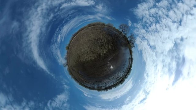 Tiny Little Planet 360 Degree - a lake and flooded land in the spring. Landscape panorama.