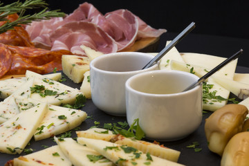 Traditional italian aperitif with proscioutto, mortadella sausage, cheese and aperol spritz drink