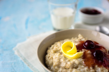 Oatmeal porridge with butter and cherry jam