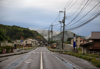 Fototapeta na wymiar Empty road running through an empty small town in rural Japan