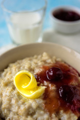 Oatmeal porridge with butter and cherry jam