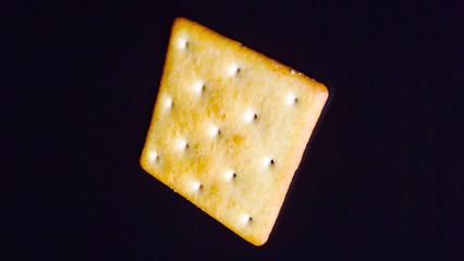 Delicious salty crackers on a black background.