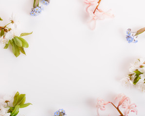 Obraz na płótnie Canvas Festive flower composition on the white wooden background. Overhead view