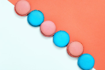 Bright colorful macaroons cakes on a white background with copy space. Assorted cookies. Festive dessert. Top view.