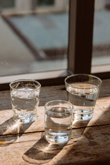 Drink a glass of water on a wooden floor.