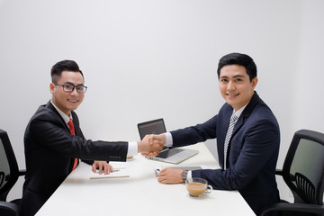 Two men handshake in the office