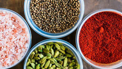 Various colorful spices in plastic containers
