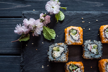 Obraz na płótnie Canvas sushi and sakura on the table