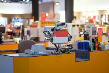 Rows of cash desks with cashiers and customers on blurry background