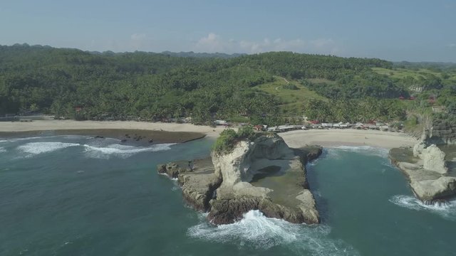 Small island at Klayar beach, East Java, Indonesia. Aerial footage in 4K, ungraded, RAW format
