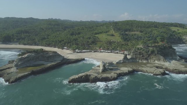 Rock tower Klayar beach, East Java, Indonesia. Aerial footage in 4K, ungraded, RAW format
