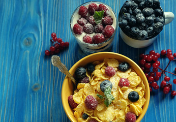 Healthy breakfast. corn flakes with raspberries and blueberries and granola with yogurt and berries.