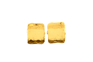 Golden ice cubes on white background.