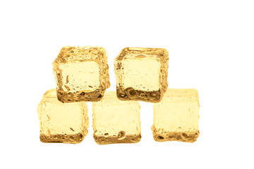 Golden ice cubes on white background.