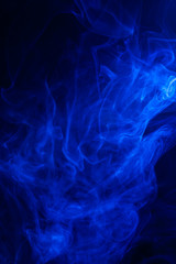 Blue smoke on black background.