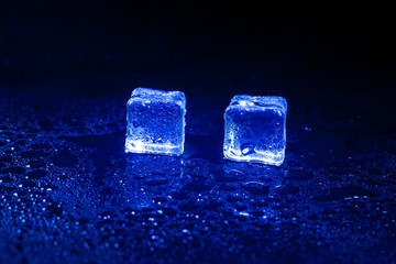 Blue ice cubes on black background.