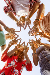 group of cheerful friends happy students building finger star shape expressing their friendship.
