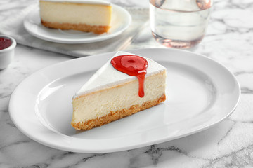 Delicious cheesecake served with sweet jam on plate
